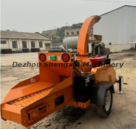 Evaluating hydraulic feed mobile wood chipper in the garden