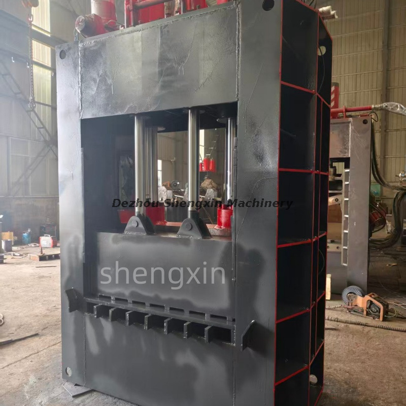 Heavy duty hydraulic guillotine shear processing metal scrap in a recycling yard